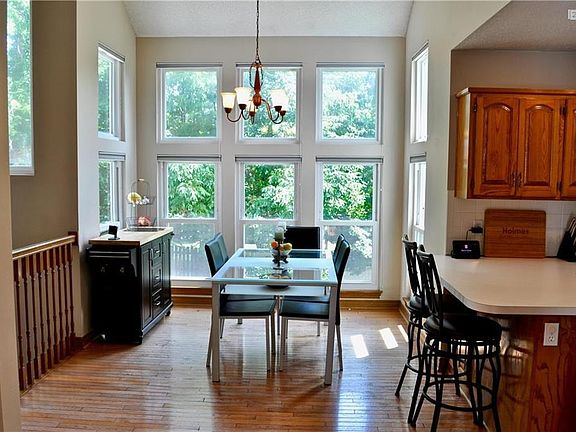 Dining area with Hardwood floors and floor to ceiling windows with tons of natural light