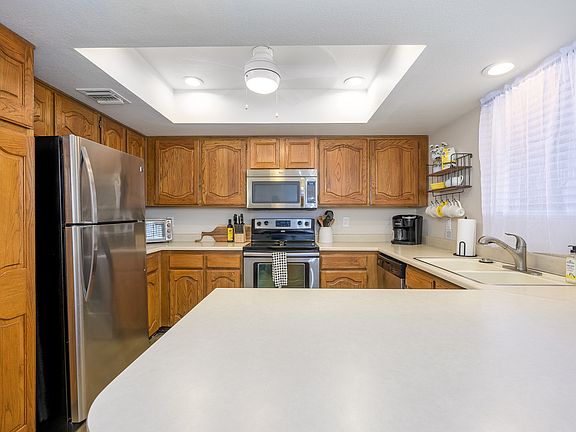 Ceiling fan and lots of light in kitchen.