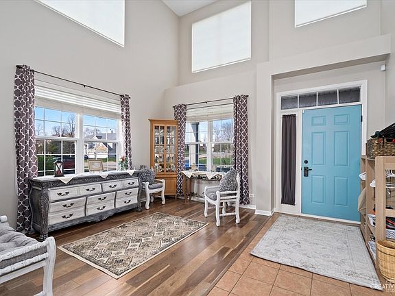 As you enter, you will find a formal living room with soaring ceilings.