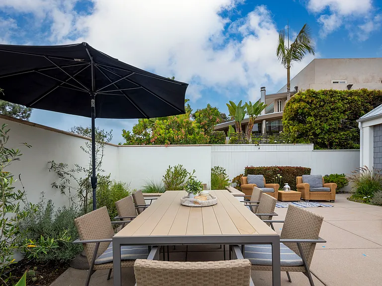 Front patio area. Whether you want to bask in the sun, play in the shoreline, or simply relax with a good book, this beach house is perfectly situated to provide an unforgettable vacation experience. 2 outdoor large dining areas!