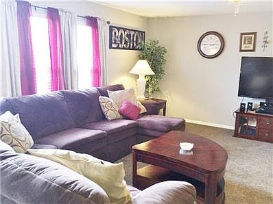 Lovely staircase leading up to bedrooms.  View of living room.