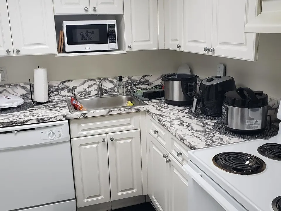 Kichen with relatively new surface and relatively new stove.