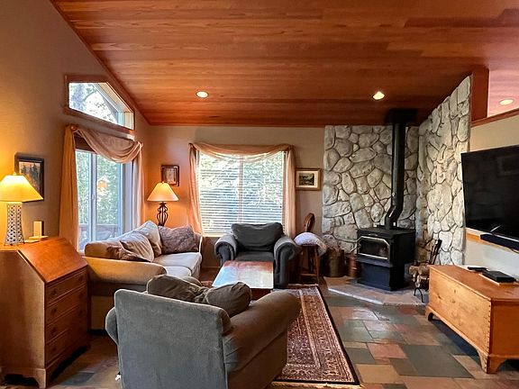 Family room (upstairs) with wood-burning fireplace, 65-inch smart TV
