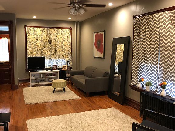 Looking from the kitchen into the living room. Nice hardwood floors, many lights and an overhead fan.