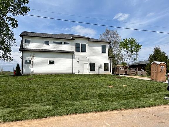 Side yard with large driveway leading to a 2 car garage.