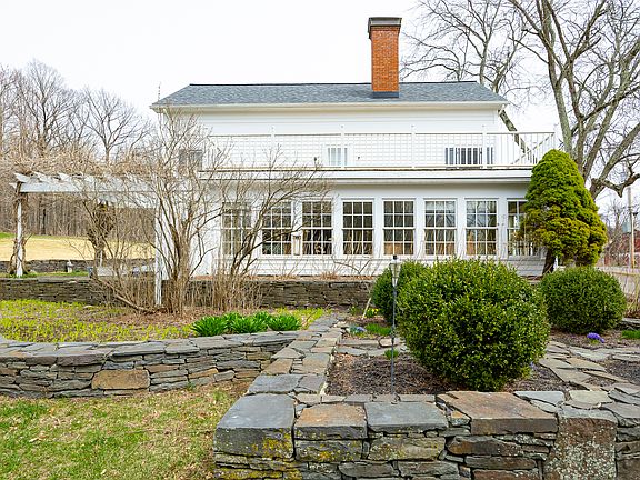 Impressive stone walls, complemented by lovely landscaping, elegantly frame the exterior