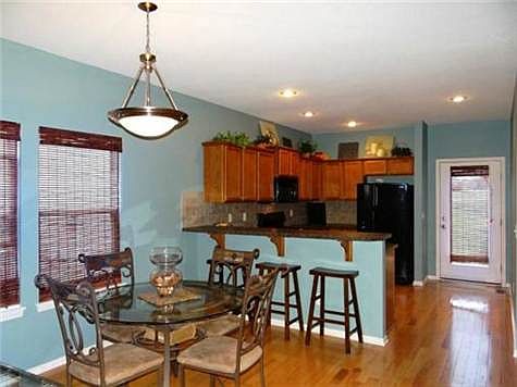 The Open Breakfast Room & Kitchen With Breakfast Bar & Hardwood