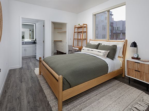 model bedroom with a bed and a large window