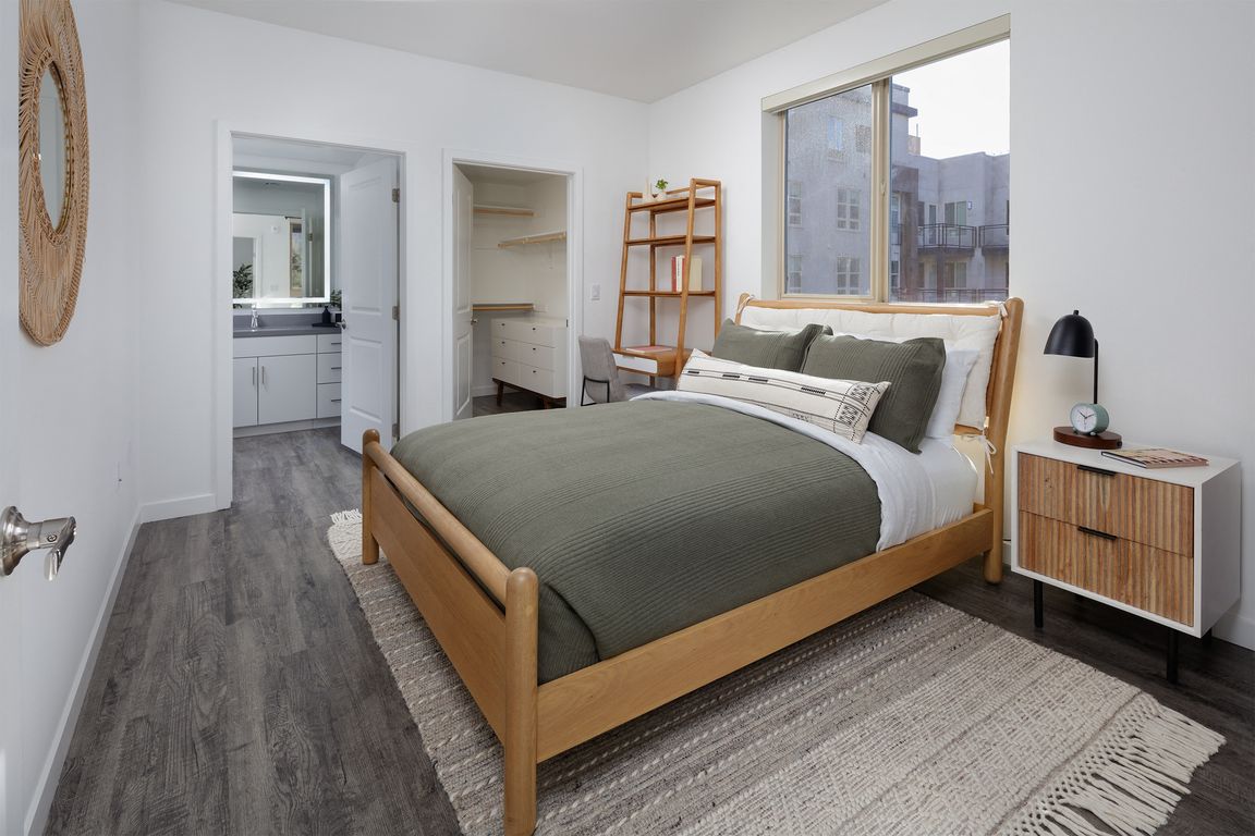 model bedroom with a bed and a large window