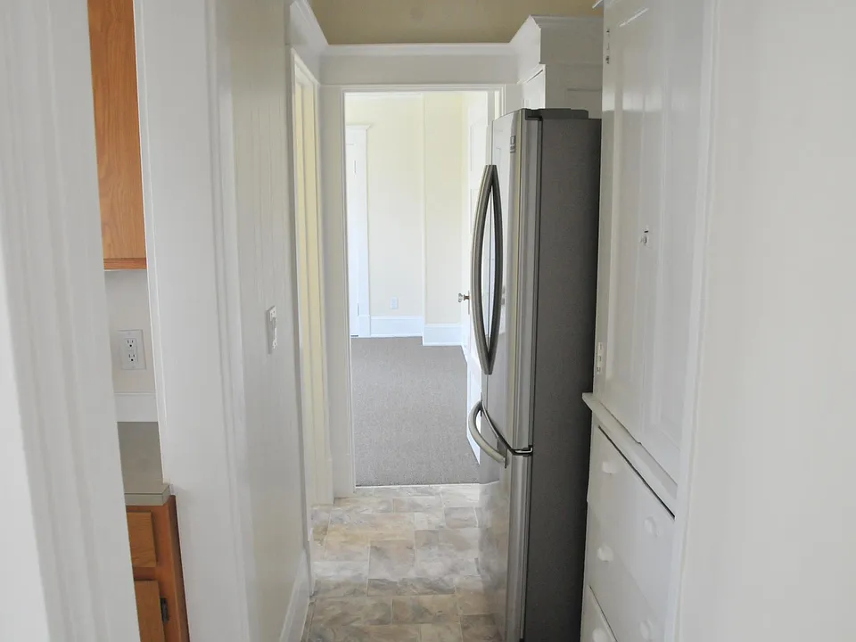 Updated fridge and one of the built in cabinets, doors with 3 shelves and 3 drawers. There are 2 cabinets like this in the hallway.