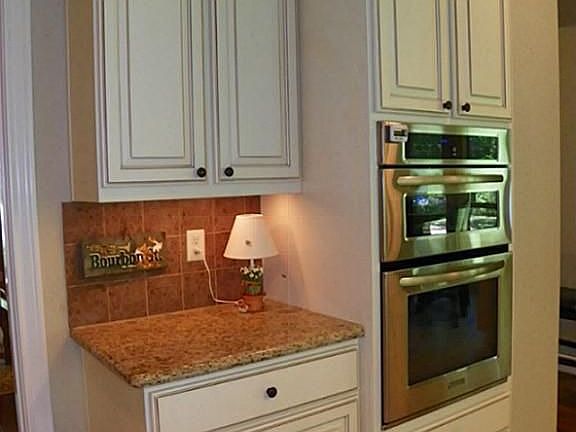 Tall cabinets and stainless steel appliances.