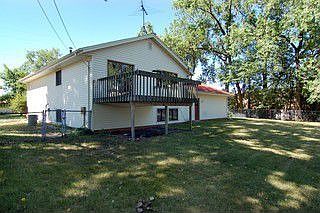 Large corne lot with fenced backyard and wood deck