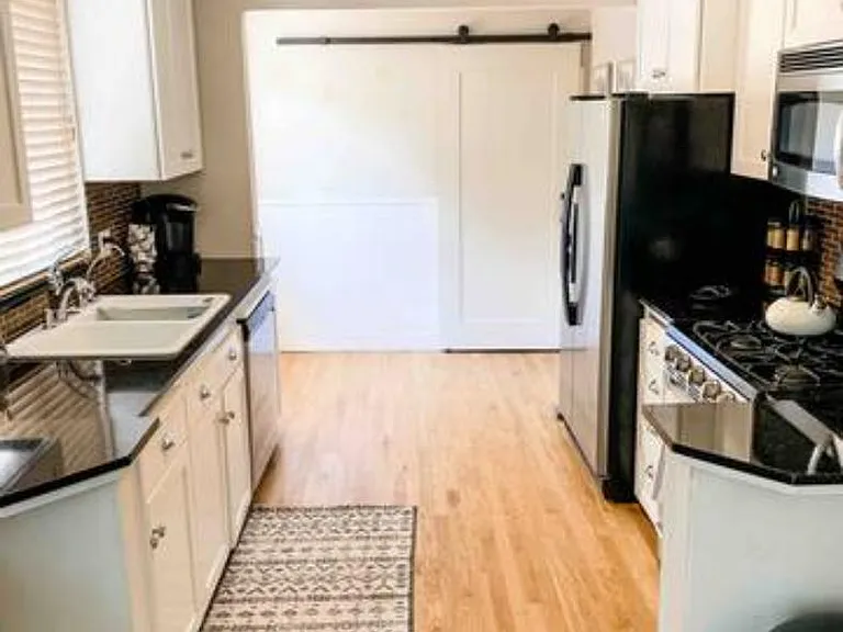 Fully stocked kitchen utensils and cooking appliances.