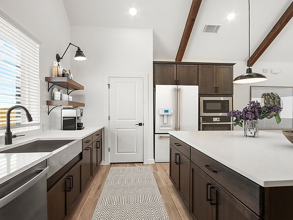 Kitchen with center island and dark stained cabinets