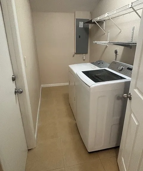 Large Laundry room with washer, dryer, shelving and additional space