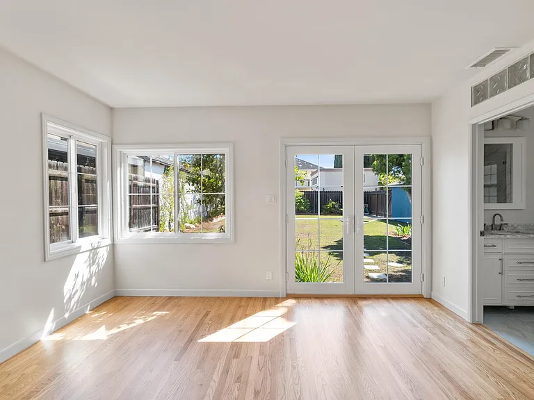 Large ensuite master bedroom view of recently planted backyard