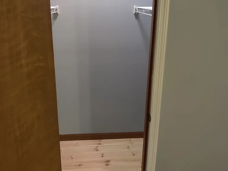 2nd Bedroom closet with custom wood floor, shelves and led light.
