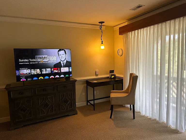 Desk with USB Outlets, 55" tv, clock and leather desk chair.