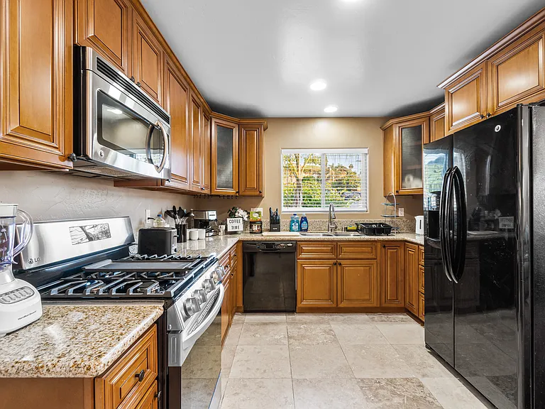 The kitchen and kitchenette are equipped with essential cooking tools, including a stove, coffee machine, microwave, fridge, and dishwasher.