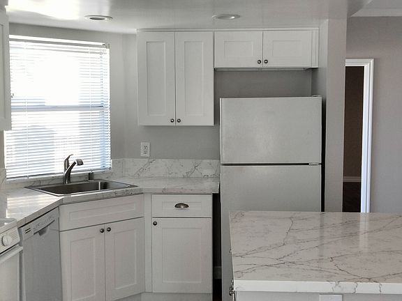 Another view of the kitchen with easy to maintain quartz counters.