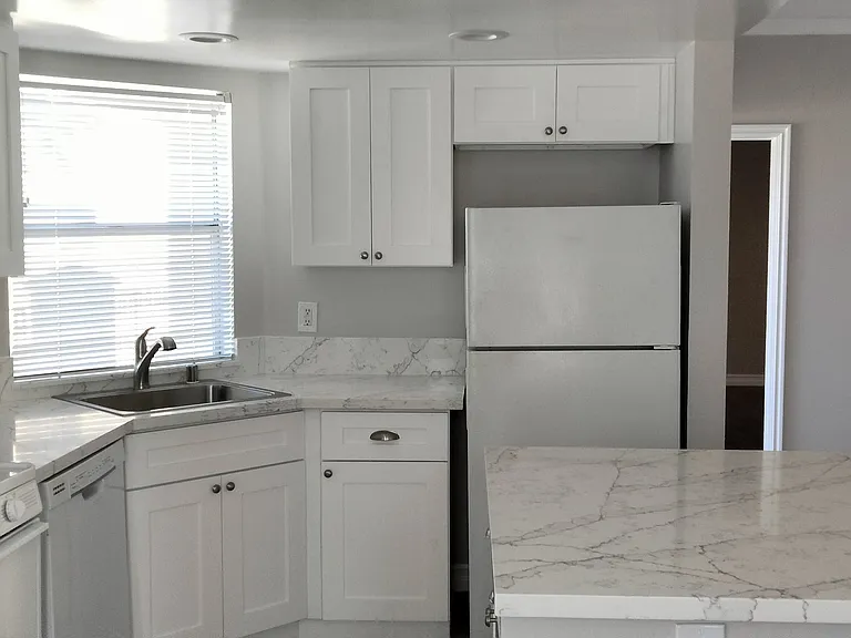 Another view of the kitchen with easy to maintain quartz counters.