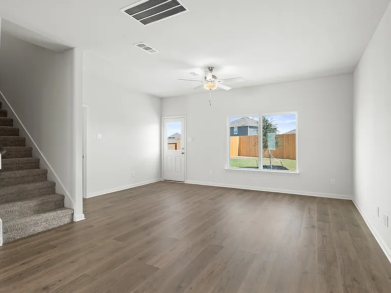 The family room is spacious and has a large window that lets in great, natural light.