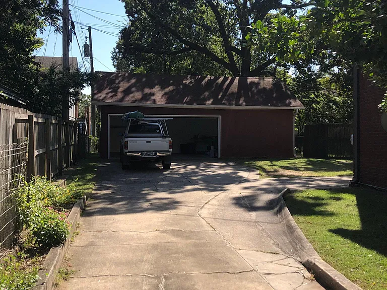 2 car garage with remote access / gated dog run for small dog to the left & behind garage.