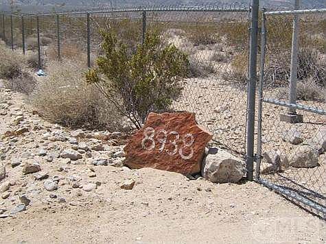 Rock outside front gate shows address as 8938 Fairlane; county shows 8936.