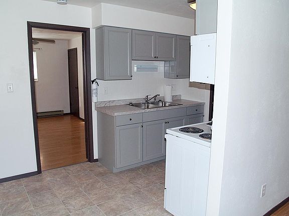 View of kitchen from living room. New flooring.
