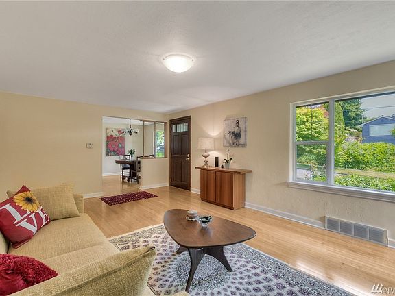 Another look at the living room from standing in front of the fireplace looking back to the front door and dining room.