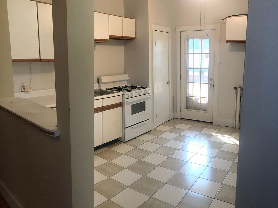 Kitchen looking toward back door and private deck. Washer and dryer hook ups are located in the kitchen.