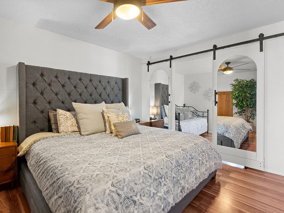 This angle shows the mirrored barn doors that separate this bedroom with the adjacent sunroom with trundle bed and adjoining deck.