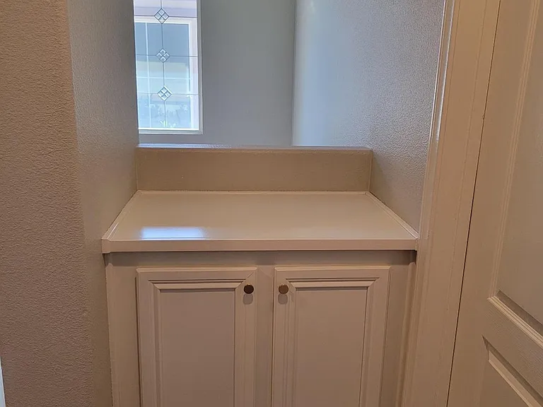 cabinet on the left of mater bedroom entry