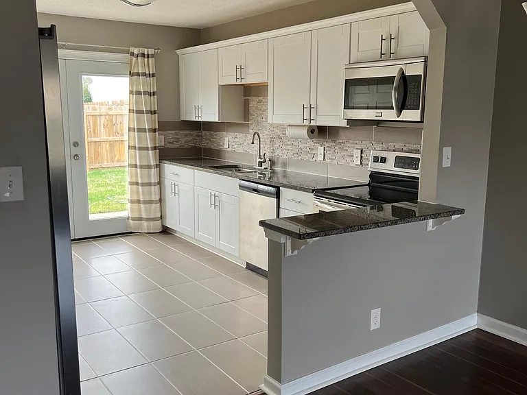 Kitchen offer tons of natural light & easy access to fenced backyard