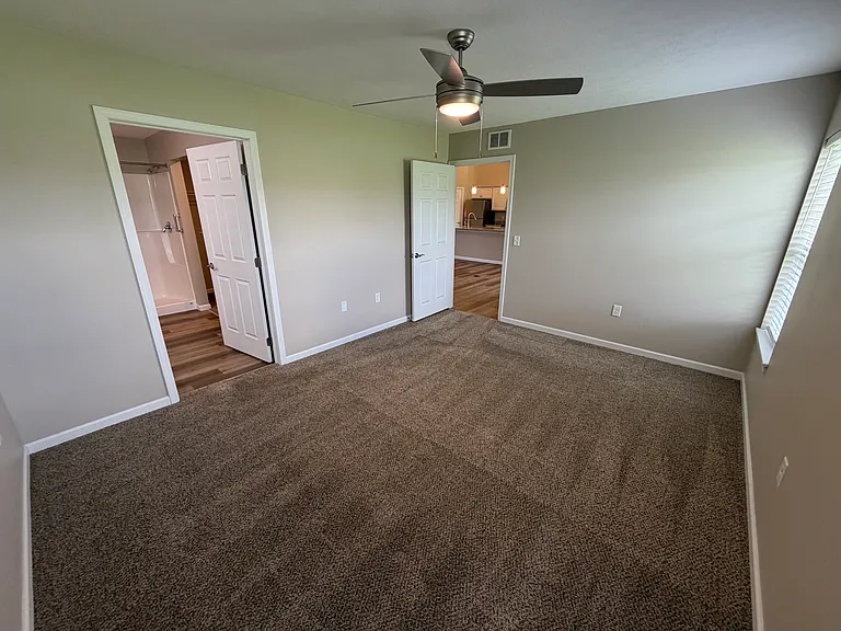 view of primary bedroom with the en suite bathroom