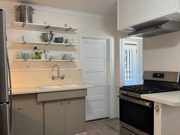 New range and hood. Back door access to the covered patio.