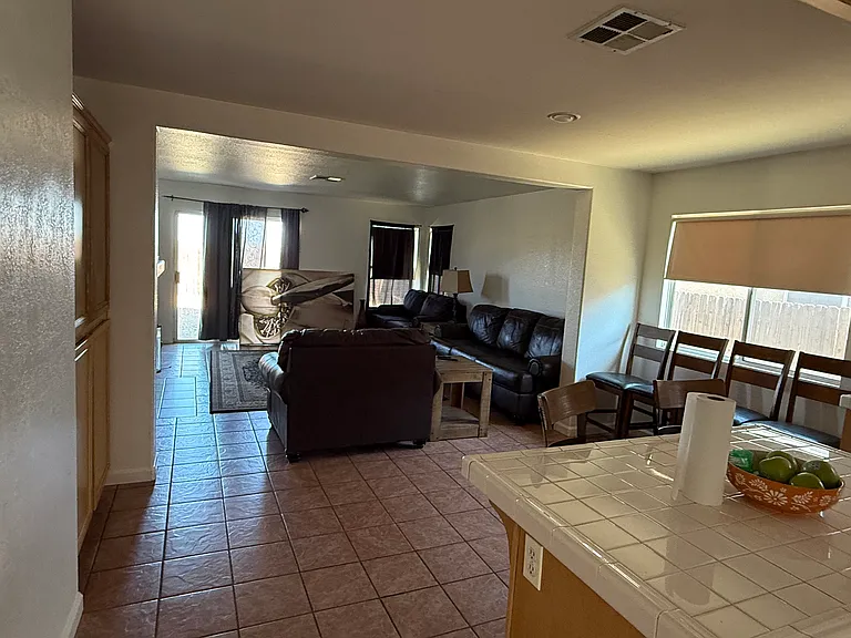 Open kitchen with eating area and spacious family room and fireplace. (Tenant in process of moving.)