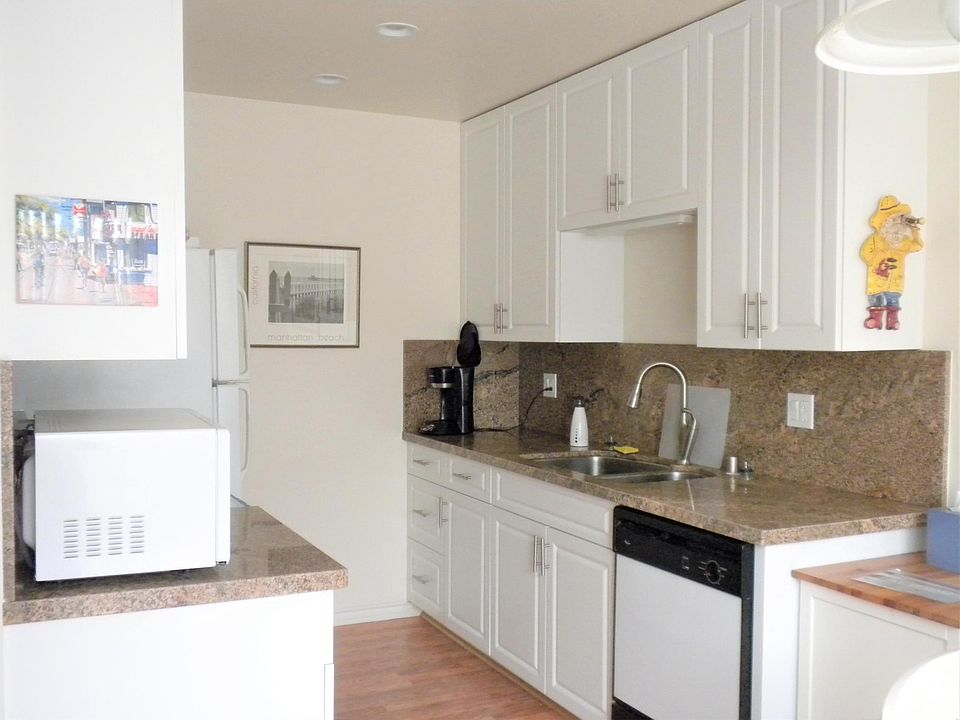 1st Level - Kitchen: stainless steel refrigerator (picture was taken before fridge was replaced), electric stove/oven, dishwasher, double sink, recessed lights, granite countertop