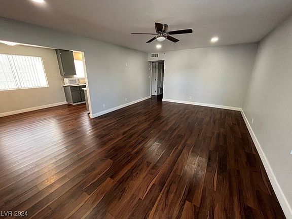 Living room area. Nice chocolate brown laminate flooring.