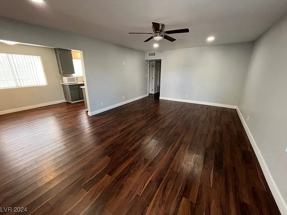 Living room area. Nice chocolate brown laminate flooring.