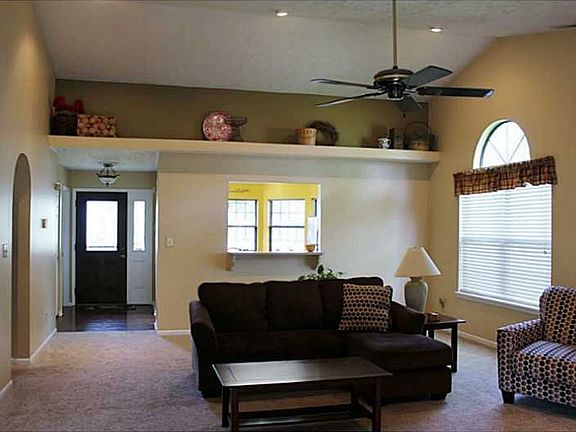 Great Room. Great room has new carpet & is freshly painted.. Display shelf and beautiful arched window.