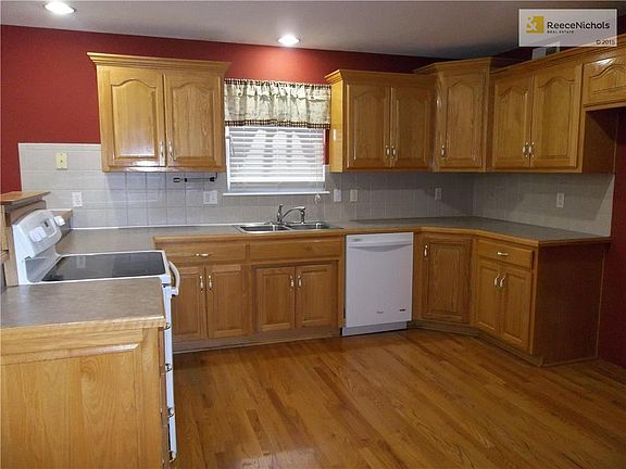 View of Spacious Kitchen area with Hardwood Floor and custom cabinets.