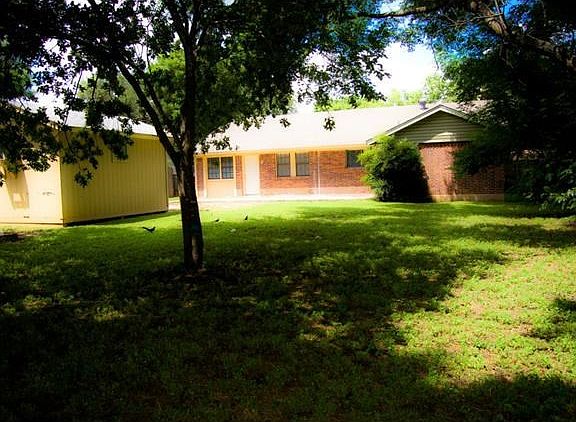 Large back yard, with lots of trees.