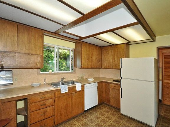 Large kitchen with lots of counter space, all appliances stay. Skylights allow the morning sun to shine in