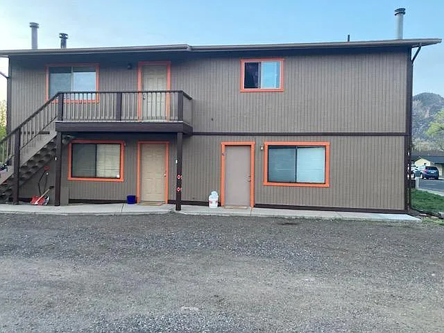 Exterior of building with parking just outside the unit