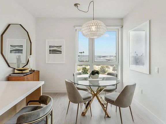 Cozy Dining Nook with Glass Table and Plush Seating