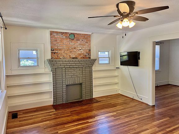 Enter into a living room with built in bookcases. Mounted TV included with rental.