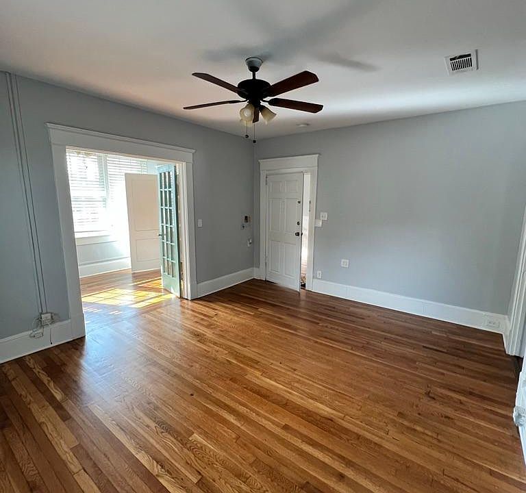 Living room (with view of sun room on the side)