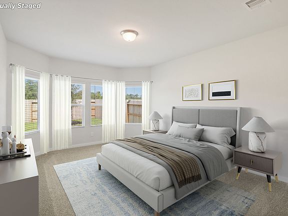 The primary bedroom of a Meritage home in Stewart s Ranch of Conroe, TX.