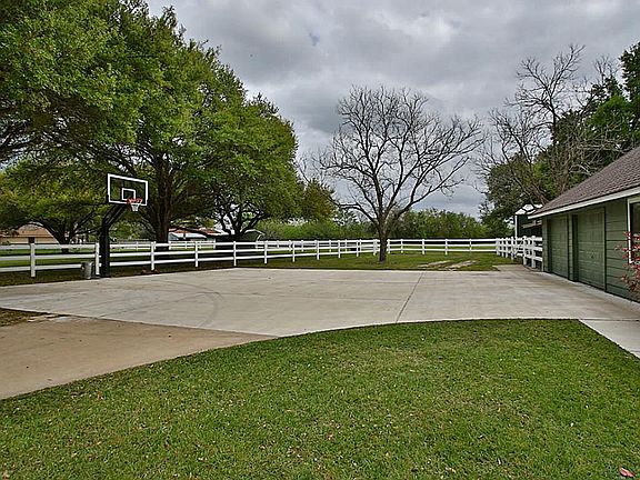 White fence outlines the horse pasture portion of the 4.5 acres on east side of the residence. Don t miss the basketball court & hoop system (left side of photo). Goal itself was ~$2,000